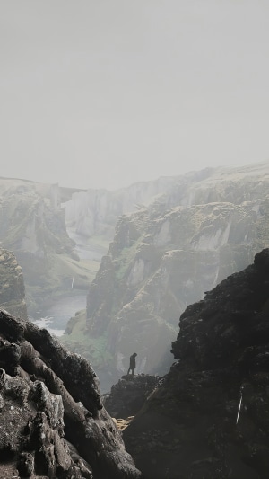Man standing on cliff edge overlooking Icelandic canyon