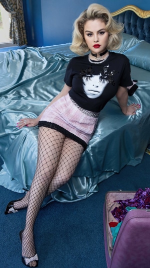 Selena Gomez on a blue satin bed