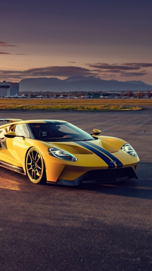 Yellow Ford GT with blue stripes on tarmac