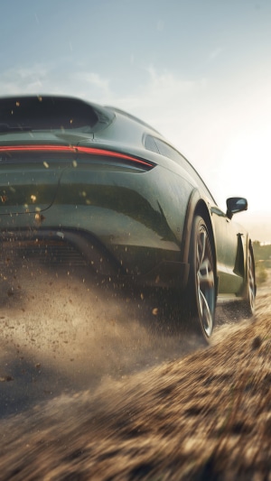 Porsche Taycan Cross Turismo driving on dirt road