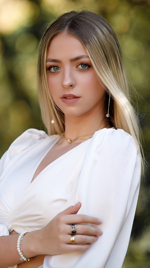 Young woman with blonde hair wearing a white dress