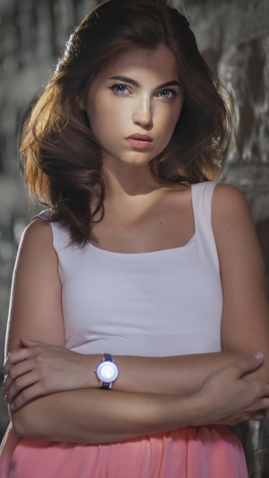 Model wearing a white top and pink skirt