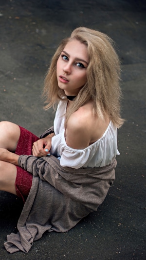Blonde girl in white top and red skirt
