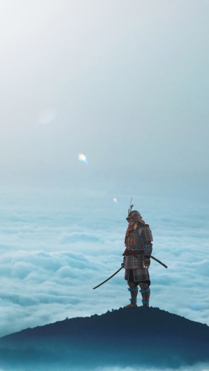 Samurai standing on a mountain peak above clouds