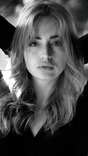 Monochrome portrait of a young woman in a black dress