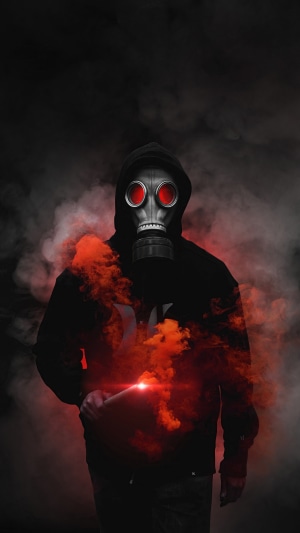 Person in gas mask with red smoke