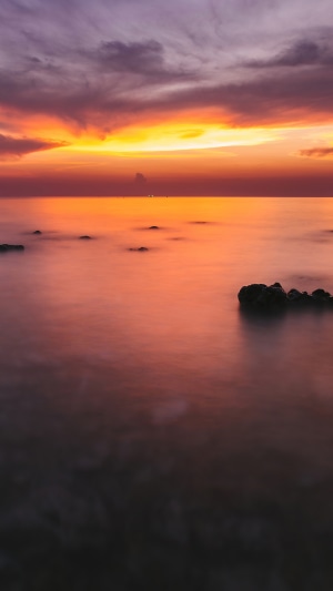 Ocean sunset with purple and orange clouds