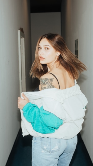 Woman with tattoo in hallway