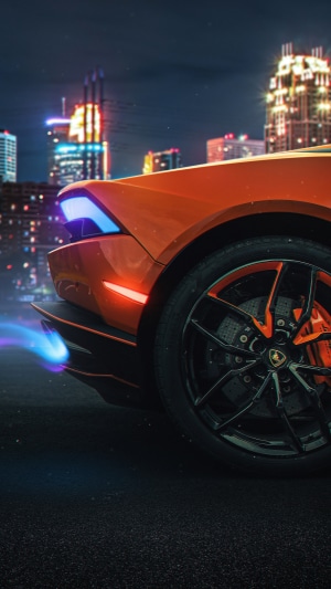 Orange Lamborghini sports car at night with city lights