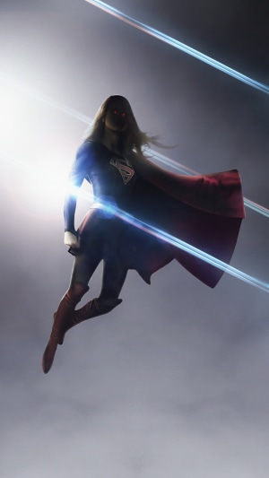 Supergirl flying with red eyes and cape