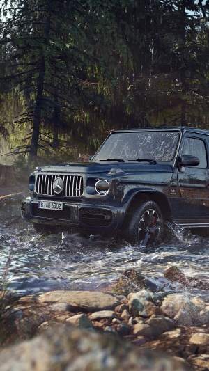 Mercedes-Benz G-Class driving through a forest stream