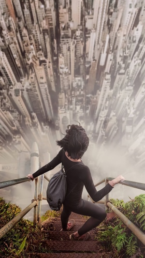 Digital art of a person on stairs overlooking a city