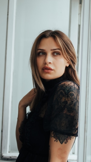 Woman with tattoo in black dress 4K
