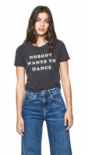 Woman wearing a t-shirt with text and jeans