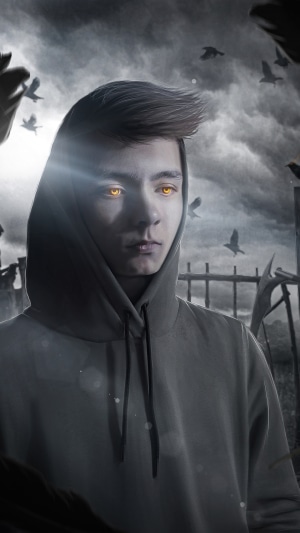 Man with glowing eyes in a hoodie