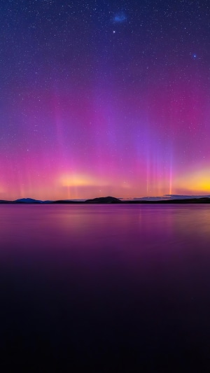 Aurora Borealis over a calm lake at night