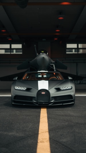 Bugatti Chiron parked in front of a jet