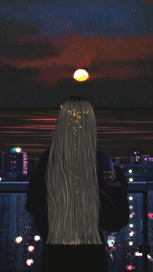 Woman on balcony watching sunset over city