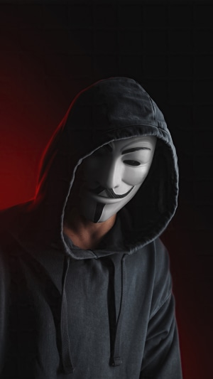 Anonymous mask wearer in a hoodie