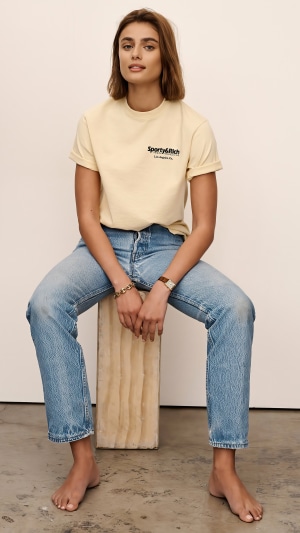 Taylor Hill wearing Sporty & Rich t-shirt and jeans