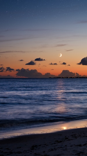 Beach at Dusk with Crescent Moon and Stars
