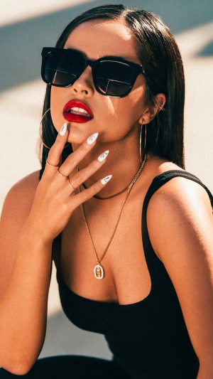 Becky G wearing sunglasses and jewelry