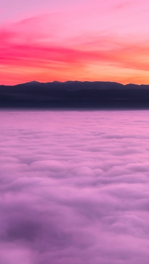 Pink clouds over mountains at sunset 4K