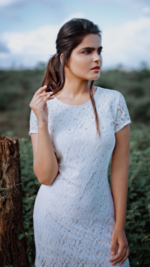 Model in white dress outdoors