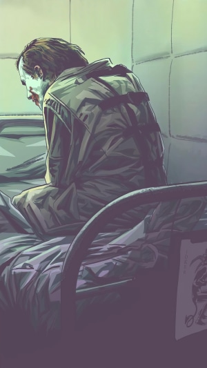 Joker from Batman sitting on a bed in a padded room