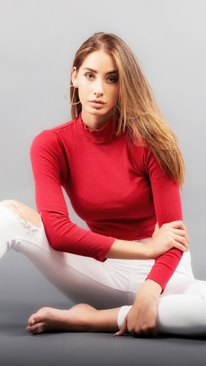 Blonde girl in red top and white ripped jeans