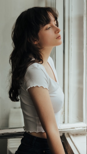 Model looking out a window