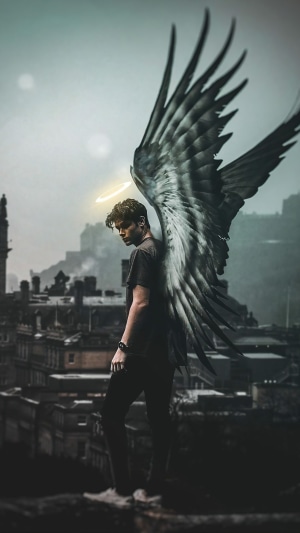 Angel with large wings overlooking a city