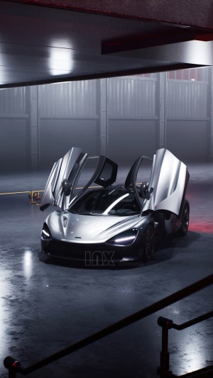 Silver McLaren 720S with doors open in a garage