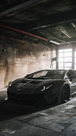 Black Lamborghini Aventador in a garage