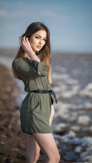 Girl in a green dress on a beach