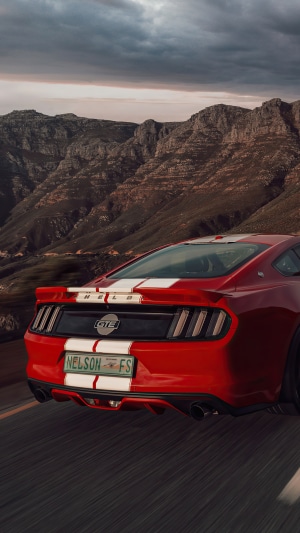 Red Ford Mustang Shelby GT on a mountain road