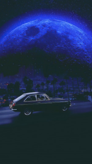 Vintage car under a large blue moon