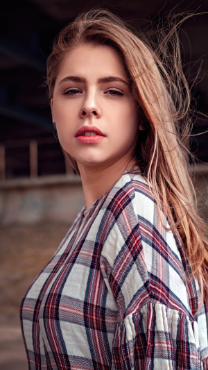 Young woman with blonde hair wearing a plaid shirt