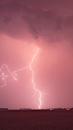 Lightning strike over a field during a storm 4K