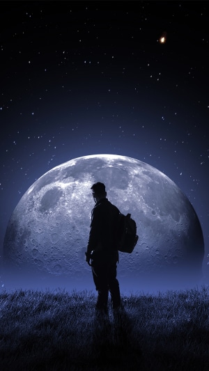 Man with backpack looking at the moon