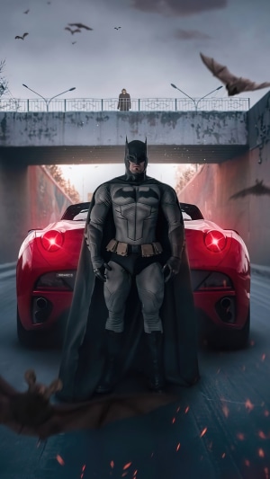 Batman standing in front of a red car with bats flying