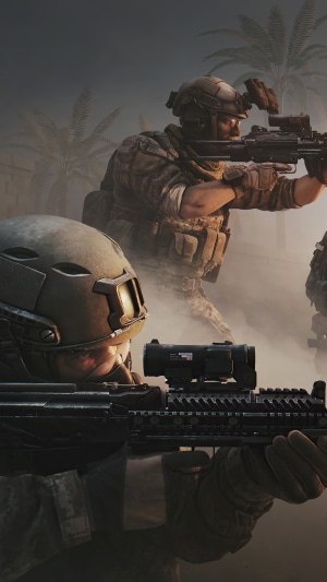 Soldiers with rifles in a dusty environment