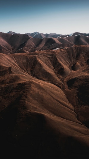 Brown mountains under a clear blue sky