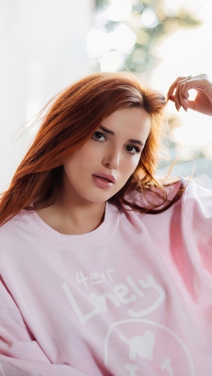 Bella Thorne wearing a pink sweatshirt