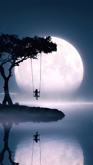 Girl on a swing under the moon