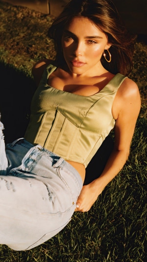 Madison Beer in a green corset and jeans