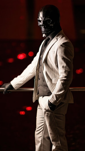 Man in Black Skull Mask and Pinstripe Suit