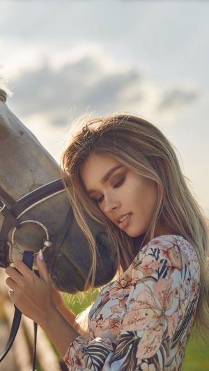Blonde model with horse in field 4K
