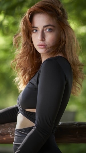 Redhead woman in black dress outdoors