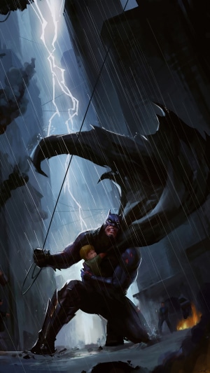 Batman holding a child during a lightning storm